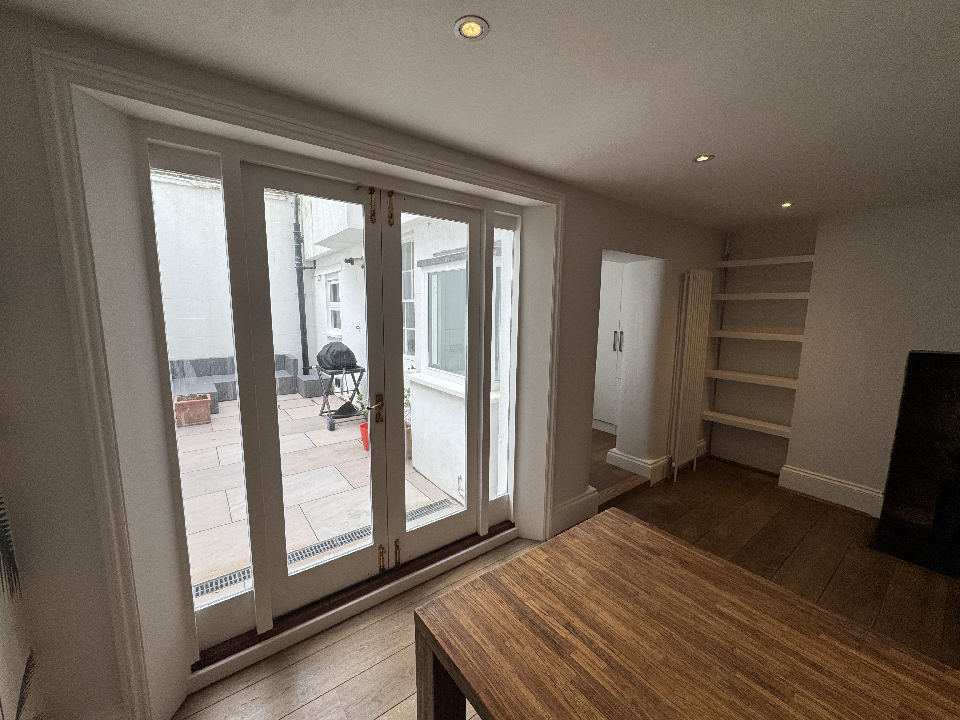 Bright living room with crisp white walls by J&R Painting Brighton